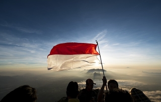 Flying a flag on top of a mountain
