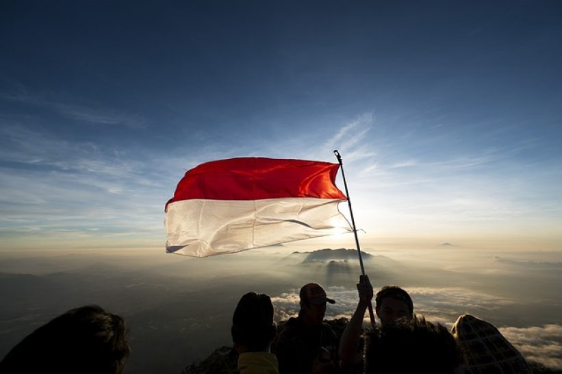 Flying a flag on top of a mountain
