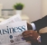 image of man in suit reading business page of newspaper