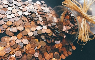 Coins spill out of a glass jar