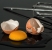 Cracked egg and a beater on a counter