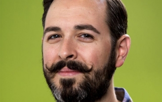 Head shot of Rand Fishkin with a green background